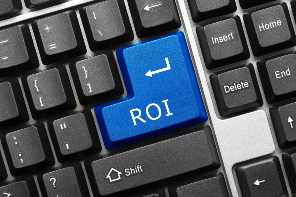 Close-up of a computer keyboard with a blue Return key labeled “ROI,” highlighting the importance of return on investment.
