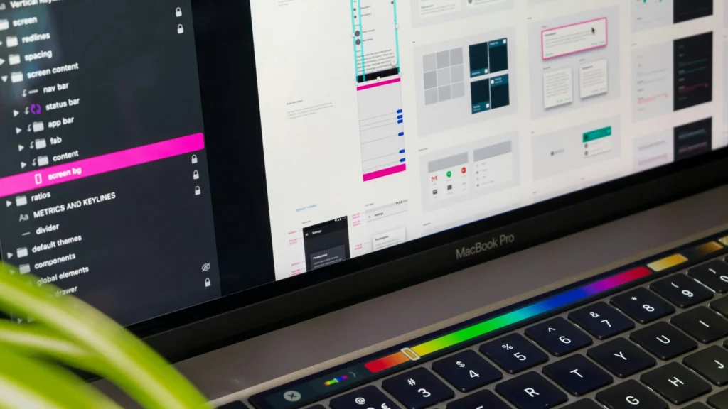 MacBook Pro showing keyboard and screen with various web components